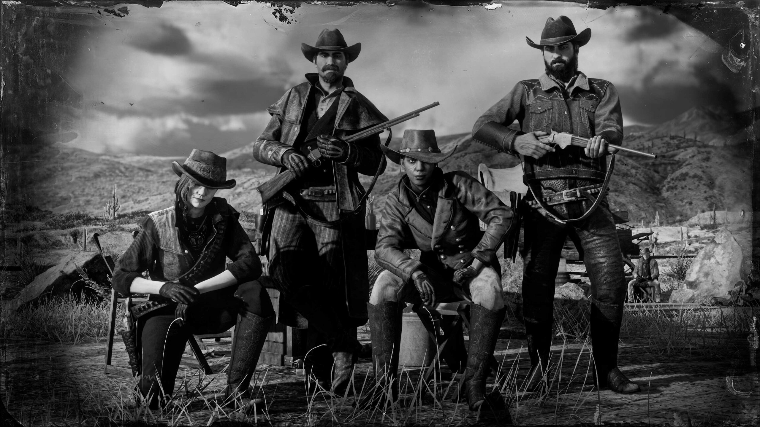 A posse of four pose together nearby rocky mountains.